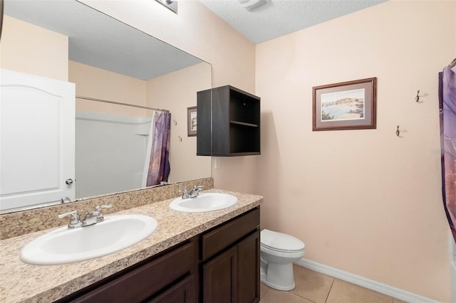 bathroom with toilet, baseboards, a sink, and tile patterned floors