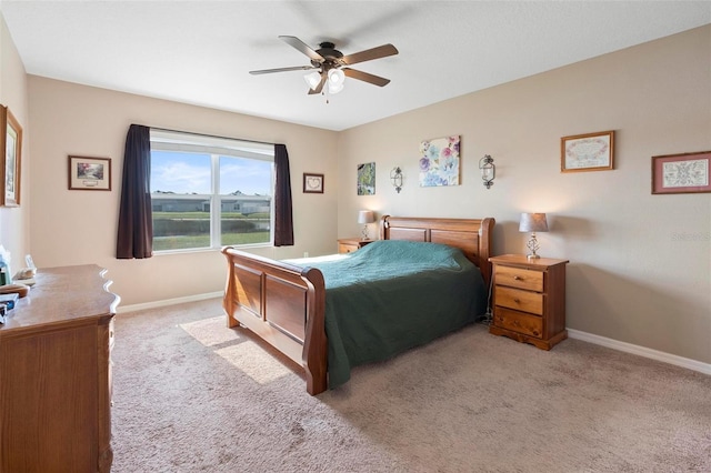 bedroom featuring light carpet, baseboards, and a ceiling fan