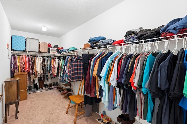 walk in closet with carpet flooring