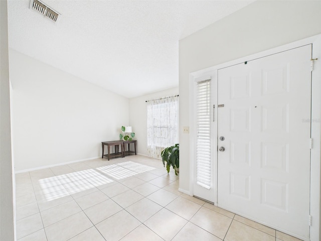 foyer featuring baseboards, visible vents, and tile patterned floors