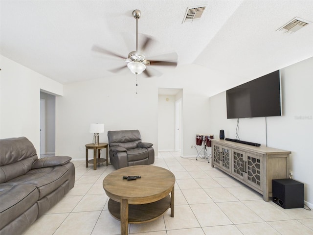 living area featuring light tile patterned floors, lofted ceiling, visible vents, and a ceiling fan