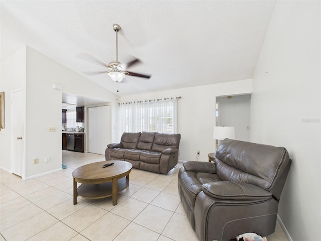 living area with lofted ceiling, light tile patterned floors, a textured ceiling, and a ceiling fan