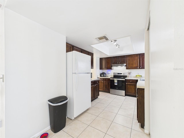 kitchen with light tile patterned floors, visible vents, electric stove, freestanding refrigerator, and light countertops