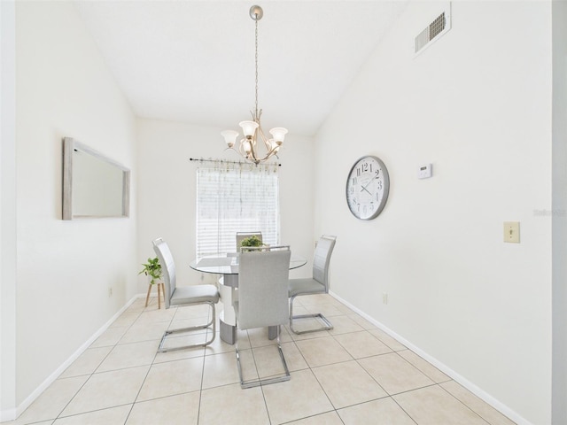 dining room featuring light tile patterned floors, lofted ceiling, visible vents, a chandelier, and baseboards