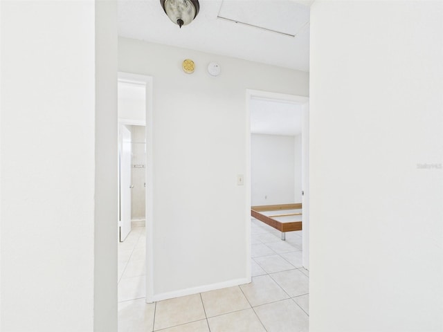 unfurnished room featuring light tile patterned floors and baseboards