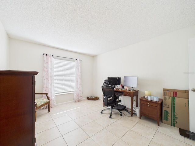 office area featuring a textured ceiling and light tile patterned floors