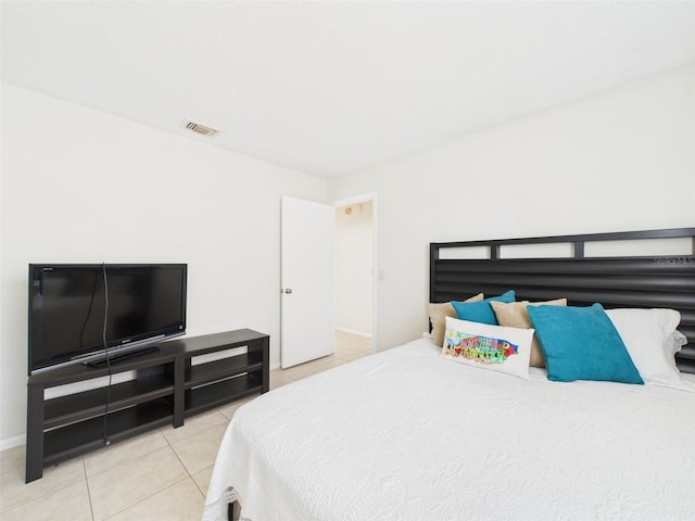 tiled bedroom with visible vents and baseboards