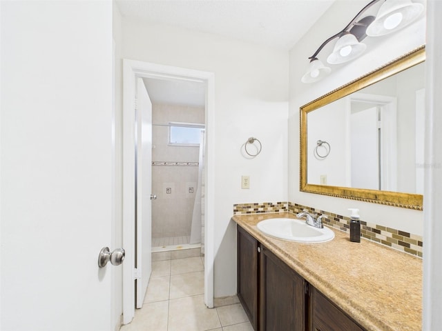 bathroom featuring a stall shower, tasteful backsplash, tile patterned floors, and vanity