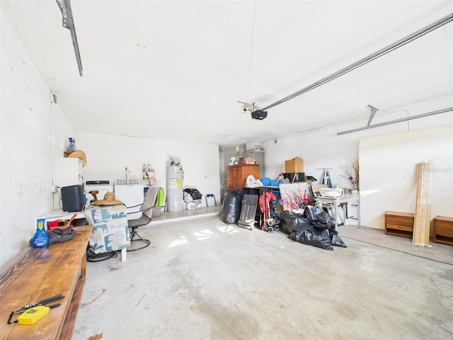 garage featuring washing machine and dryer, water heater, and a garage door opener