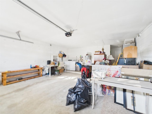 garage with washer / clothes dryer and a garage door opener