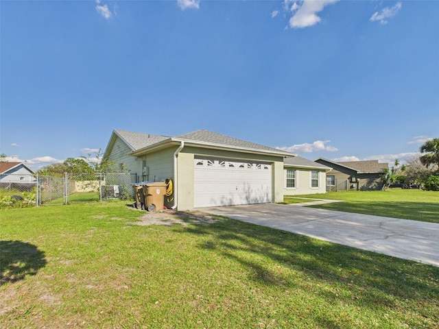 view of side of property with driveway, an attached garage, a gate, fence, and a yard