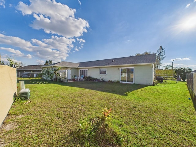 back of house with a yard and fence