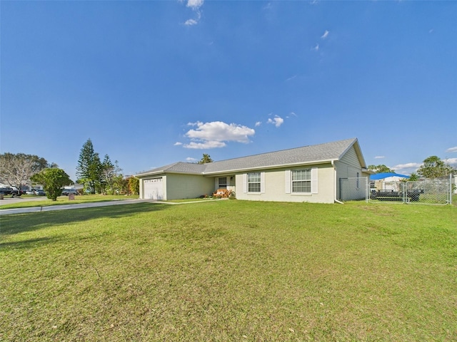 single story home with a garage, a front yard, fence, and a gate