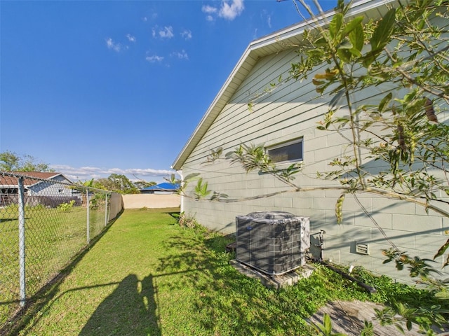 view of yard with cooling unit and fence