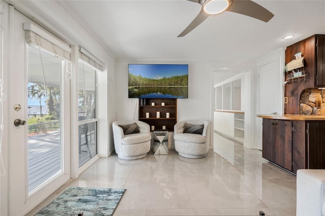 sitting room with marble finish floor and ceiling fan