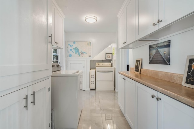 washroom with marble finish floor, laundry area, and washing machine and clothes dryer