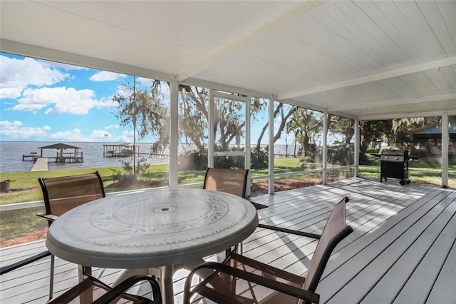 wooden deck with a water view and grilling area