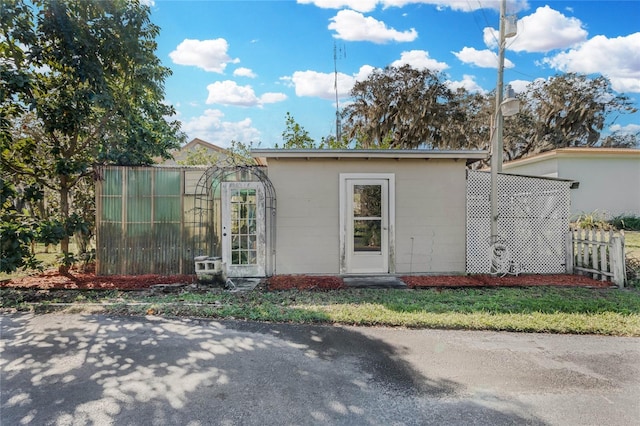 exterior space featuring fence and an outbuilding