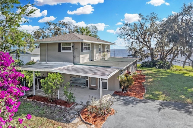 view of front facade featuring a front yard and a water view