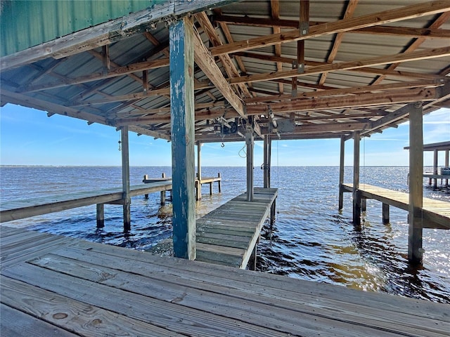 dock area with a water view and boat lift