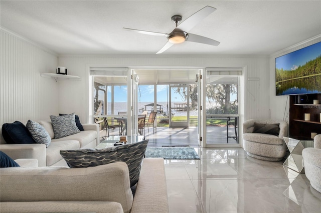 living area with ornamental molding and ceiling fan