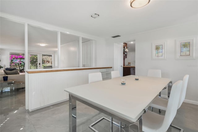 dining room featuring ornamental molding and visible vents