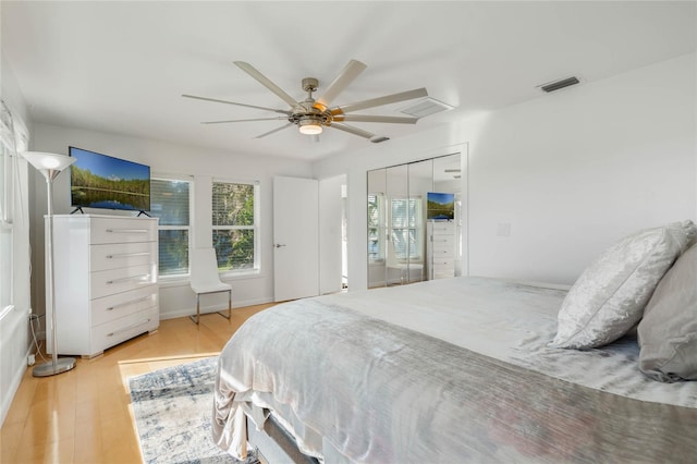 bedroom with visible vents, ceiling fan, and light wood finished floors