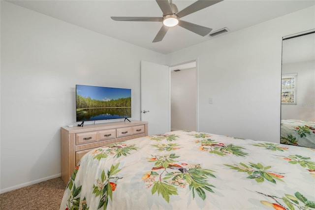 carpeted bedroom with visible vents, ceiling fan, and baseboards