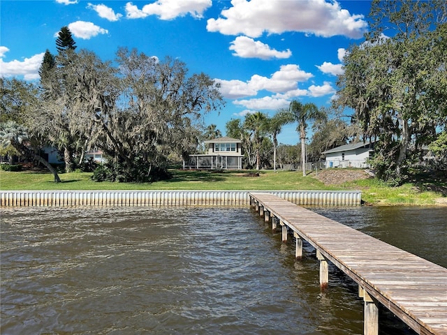 dock area featuring a water view and a lawn