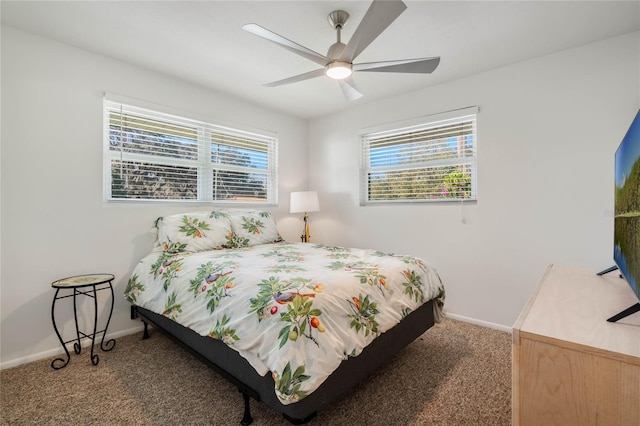 carpeted bedroom with multiple windows, baseboards, and a ceiling fan