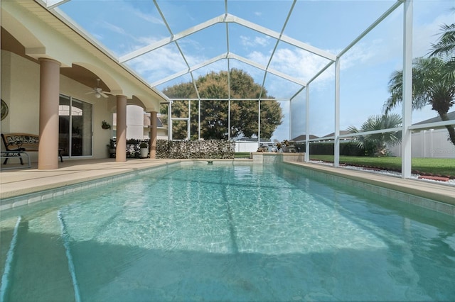 outdoor pool featuring a ceiling fan, a lanai, and a patio area