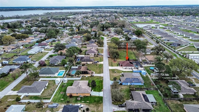 bird's eye view featuring a water view and a residential view