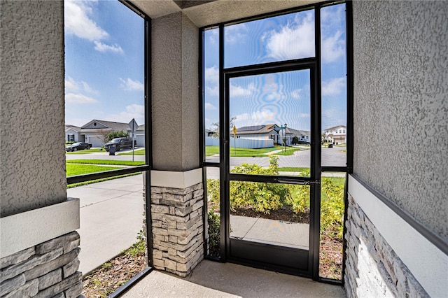 sunroom featuring a residential view