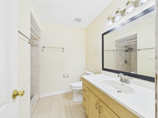 91 W Cedarwood Cir, Kissimmee, FL 34743 - bathroom with a shower stall, toilet, tile patterned flooring, vanity, and baseboards
