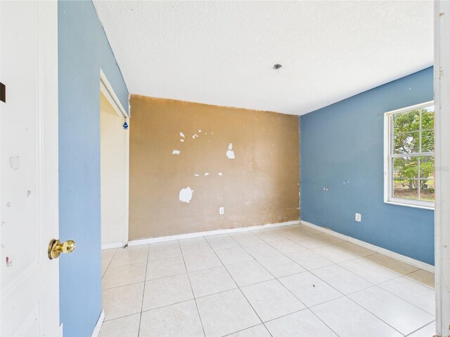 91 W Cedarwood Cir, Kissimmee, FL 34743 - unfurnished room featuring a textured ceiling, baseboards, and tile patterned floors