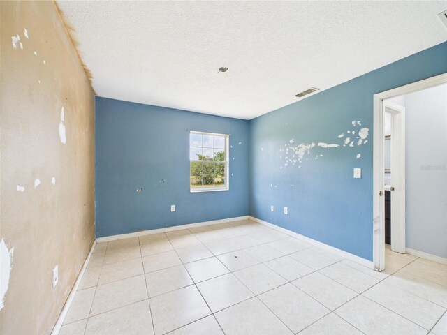 91 W Cedarwood Cir, Kissimmee, FL 34743 - tiled empty room featuring a textured ceiling and baseboards