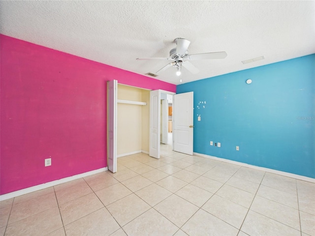 91 W Cedarwood Cir, Kissimmee, FL 34743 - unfurnished bedroom with baseboards, a ceiling fan, a textured ceiling, tile patterned floors, and a closet