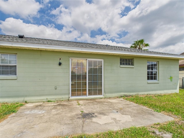 91 W Cedarwood Cir, Kissimmee, FL 34743 - rear view of house with a patio and roof with shingles