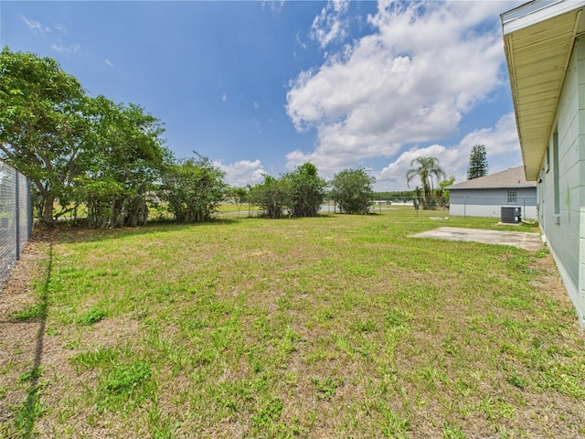 91 W Cedarwood Cir, Kissimmee, FL 34743 - view of yard featuring central AC unit and fence