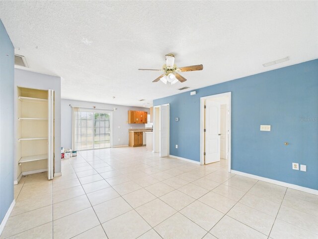 91 W Cedarwood Cir, Kissimmee, FL 34743 - unfurnished living room featuring ceiling fan, baseboards, light tile patterned floors, and a textured ceiling