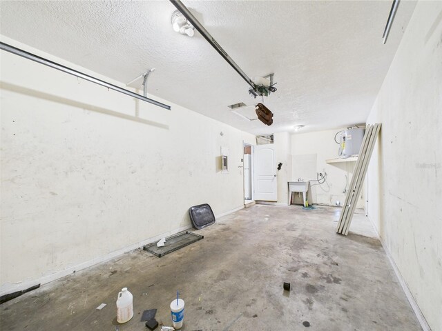 91 W Cedarwood Cir, Kissimmee, FL 34743 - garage featuring a sink, baseboards, and electric panel