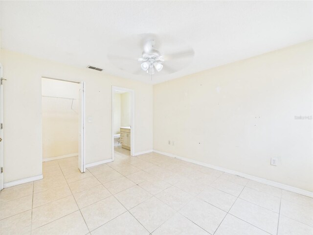 91 W Cedarwood Cir, Kissimmee, FL 34743 - unfurnished bedroom featuring light tile patterned flooring, a closet, a ceiling fan, and baseboards