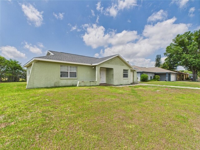 91 W Cedarwood Cir, Kissimmee, FL 34743 - ranch-style home with stucco siding, a front lawn, and a garage