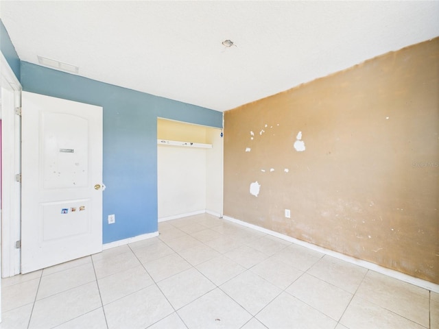 91 W Cedarwood Cir, Kissimmee, FL 34743 - unfurnished bedroom with baseboards, a closet, and light tile patterned floors