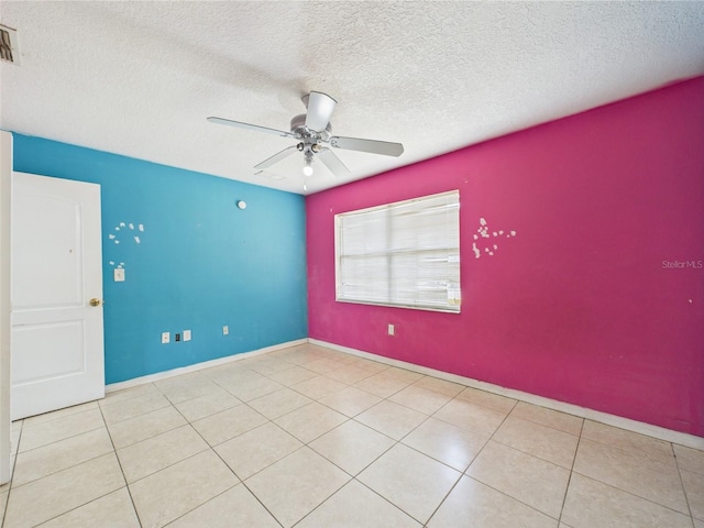 91 W Cedarwood Cir, Kissimmee, FL 34743 - tiled spare room with a ceiling fan, a textured ceiling, and baseboards
