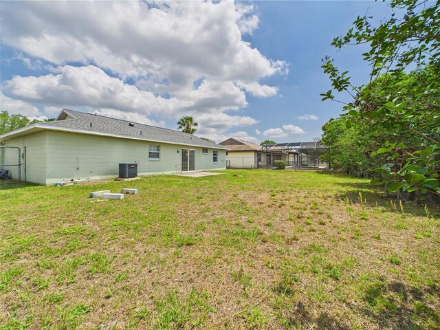 91 W Cedarwood Cir, Kissimmee, FL 34743 - view of yard with a patio area, cooling unit, and glass enclosure