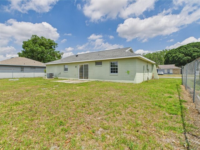 91 W Cedarwood Cir, Kissimmee, FL 34743 - back of house with a patio area, central AC unit, and concrete block siding