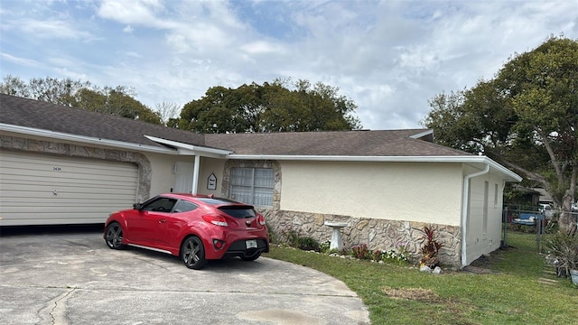 view of front of property featuring roof with shingles, stucco siding, concrete driveway, an attached garage, and stone siding