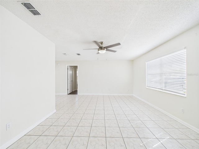 2434 Mill Run Blvd, Kissimmee, FL 34744 - empty room with a textured ceiling, visible vents, a ceiling fan, light tile patterned floors, and baseboards