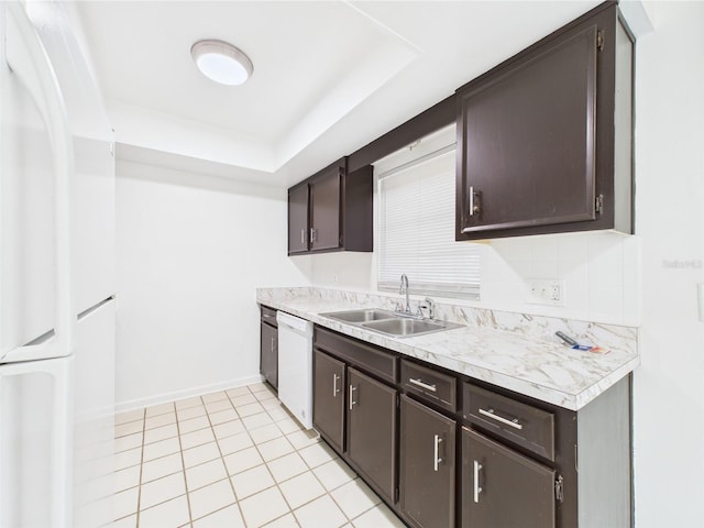 2434 Mill Run Blvd, Kissimmee, FL 34744 - kitchen with dark brown cabinets, white appliances, and a sink